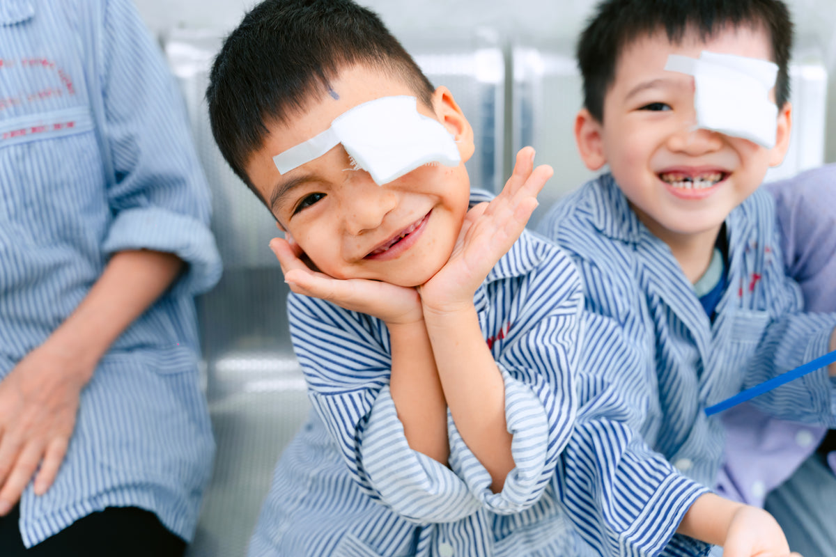 Children smiling after receiving sight-saving eye care supported by Orbis Canada
